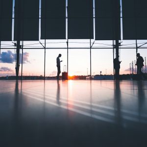 People in backlight leaving at the airport